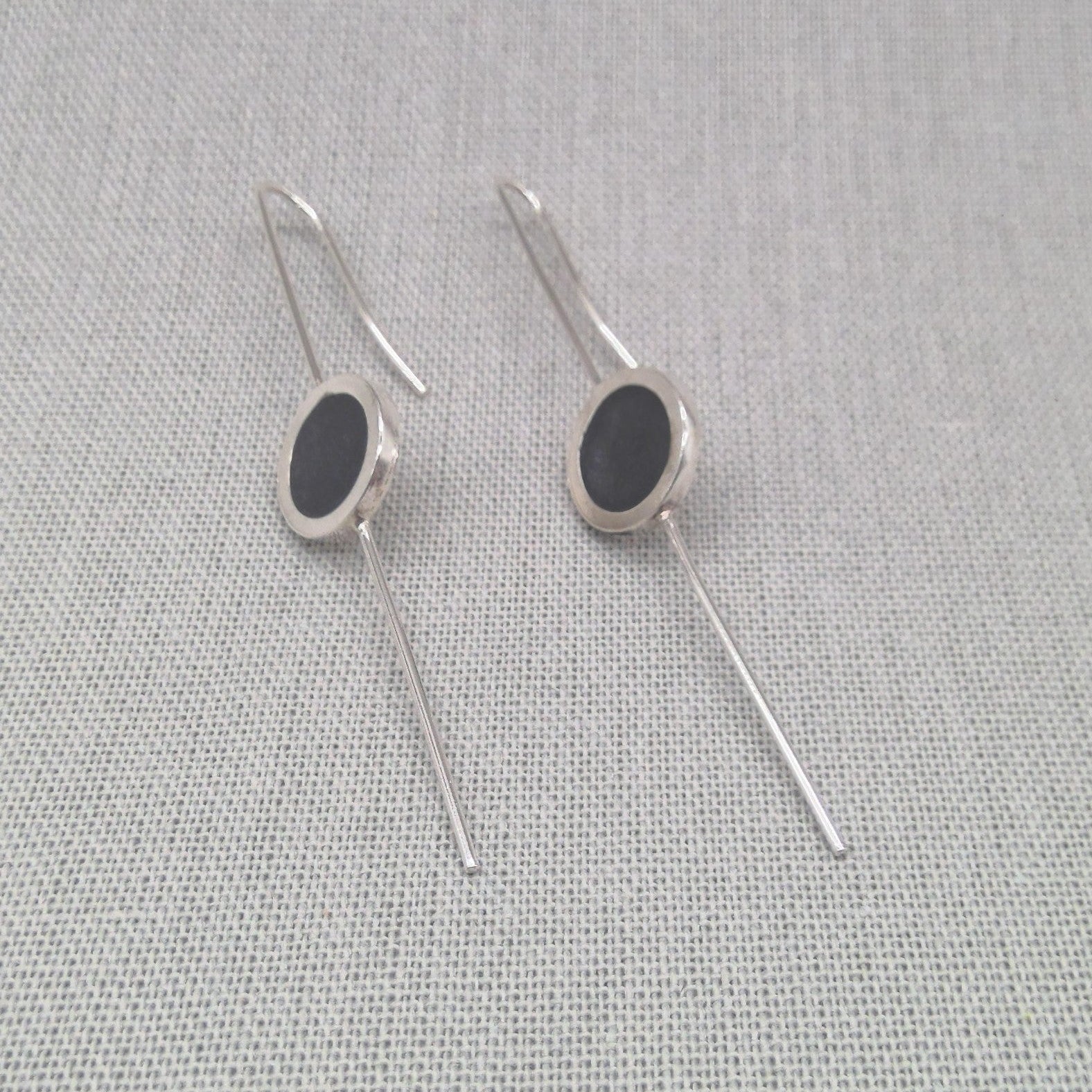 Silver and resin earrings crossed in alternate styling