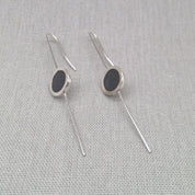Silver and resin earrings crossed in alternate styling