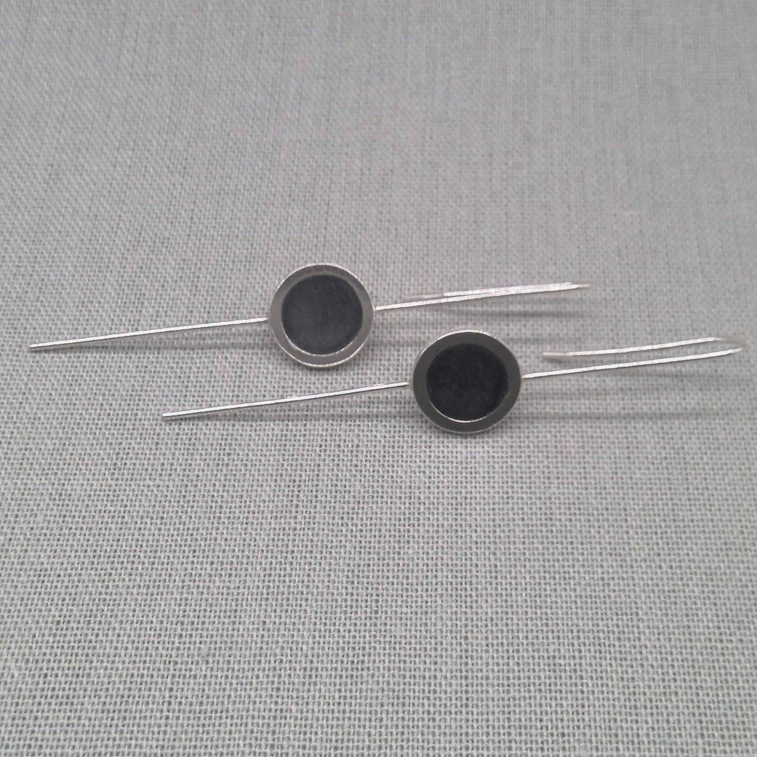 Flat lay detail of silver and resin earring design