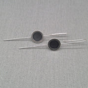 Flat lay detail of silver and resin earring design