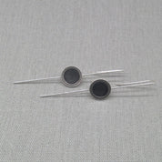 Horizontal flat lay of silver and resin drop earrings