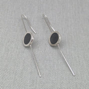 Silver and resin earrings styled in straight drop position