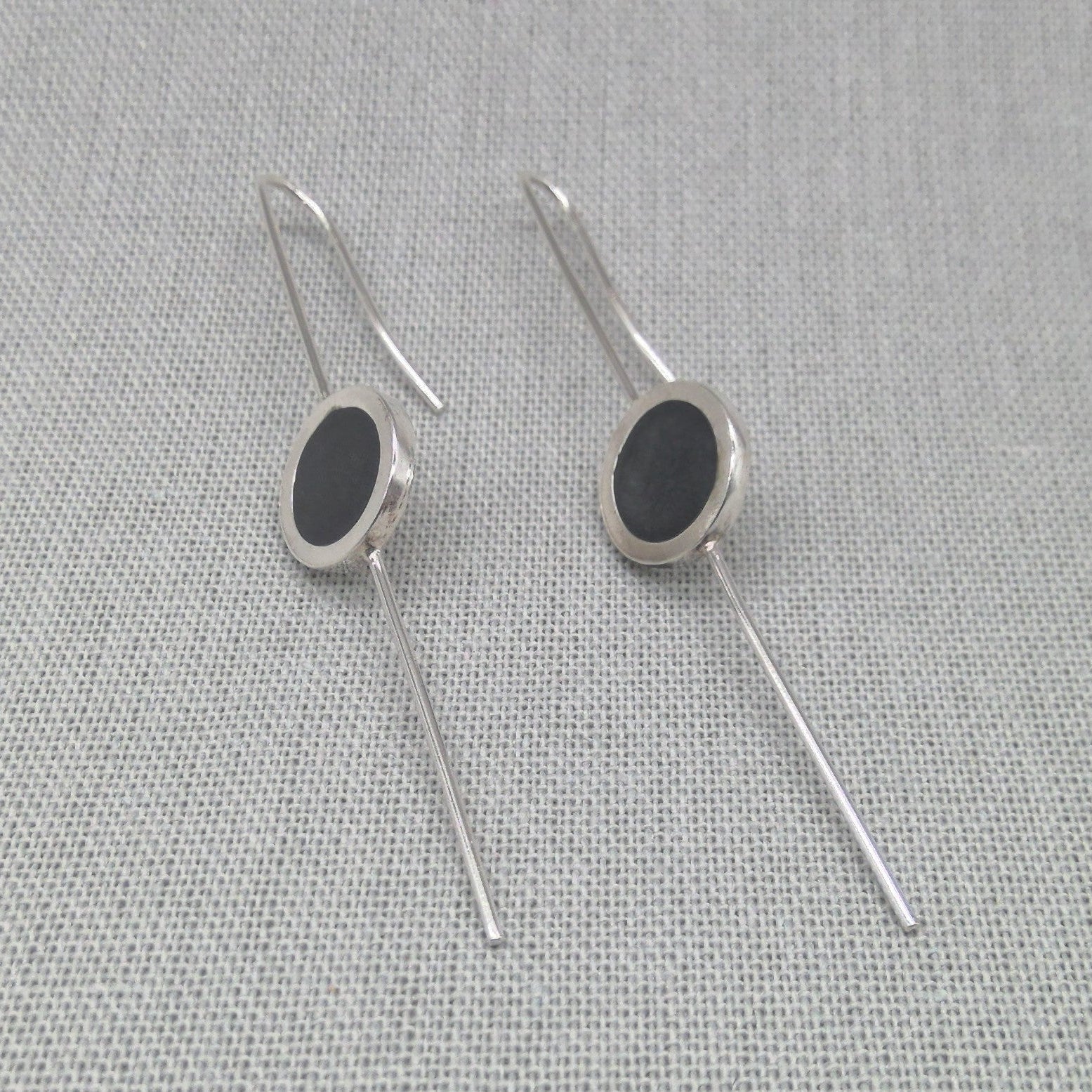 Silver and resin earrings styled in straight drop position