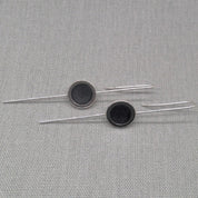 Horizontal flat lay of silver and resin drop earrings