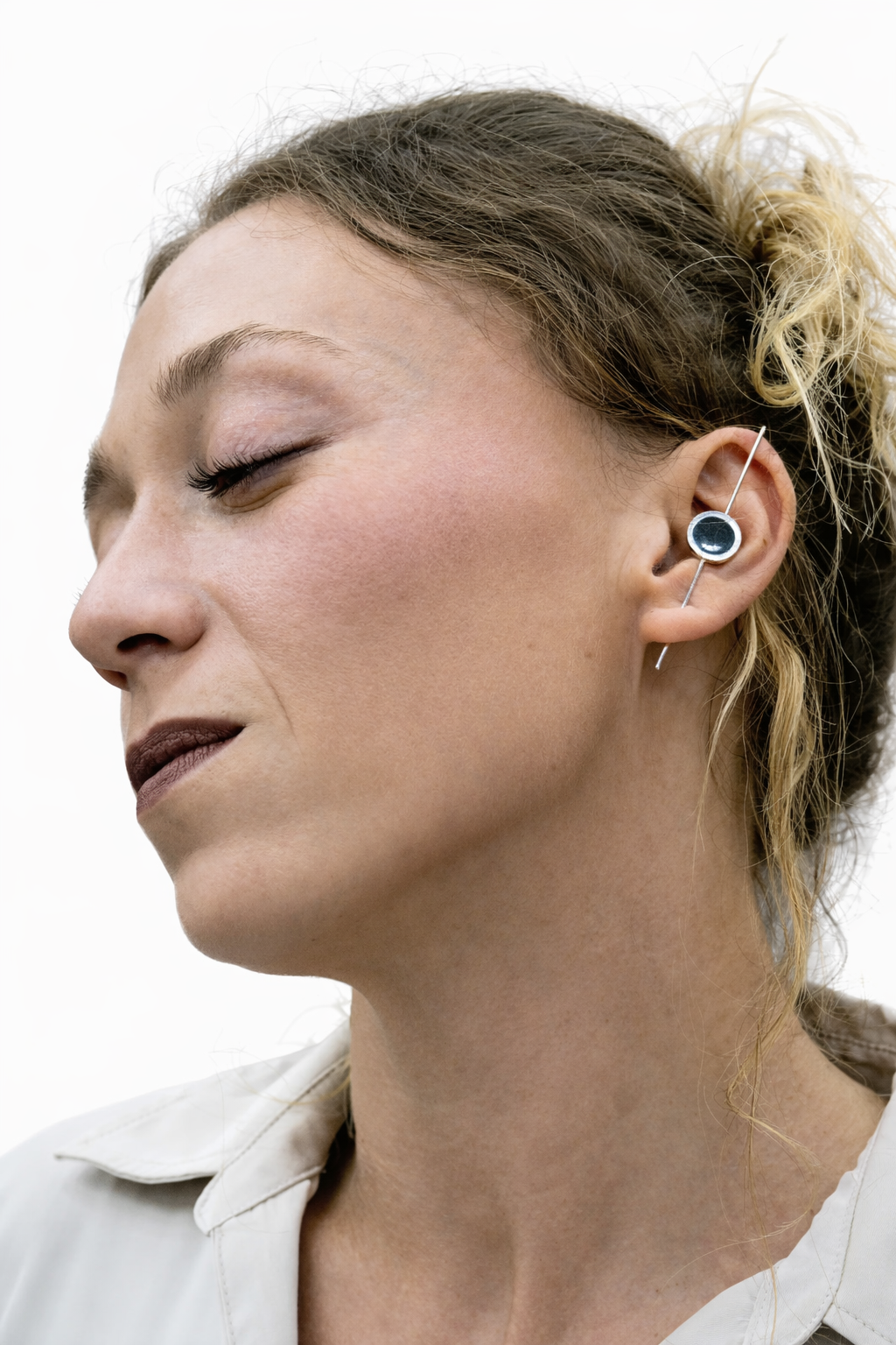 Model wearing silver and resin earrings, styled look
