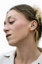 Model wearing silver and resin earrings, styled look