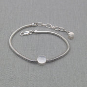 Detail of adjustable clasp on silver snake chain bracelet