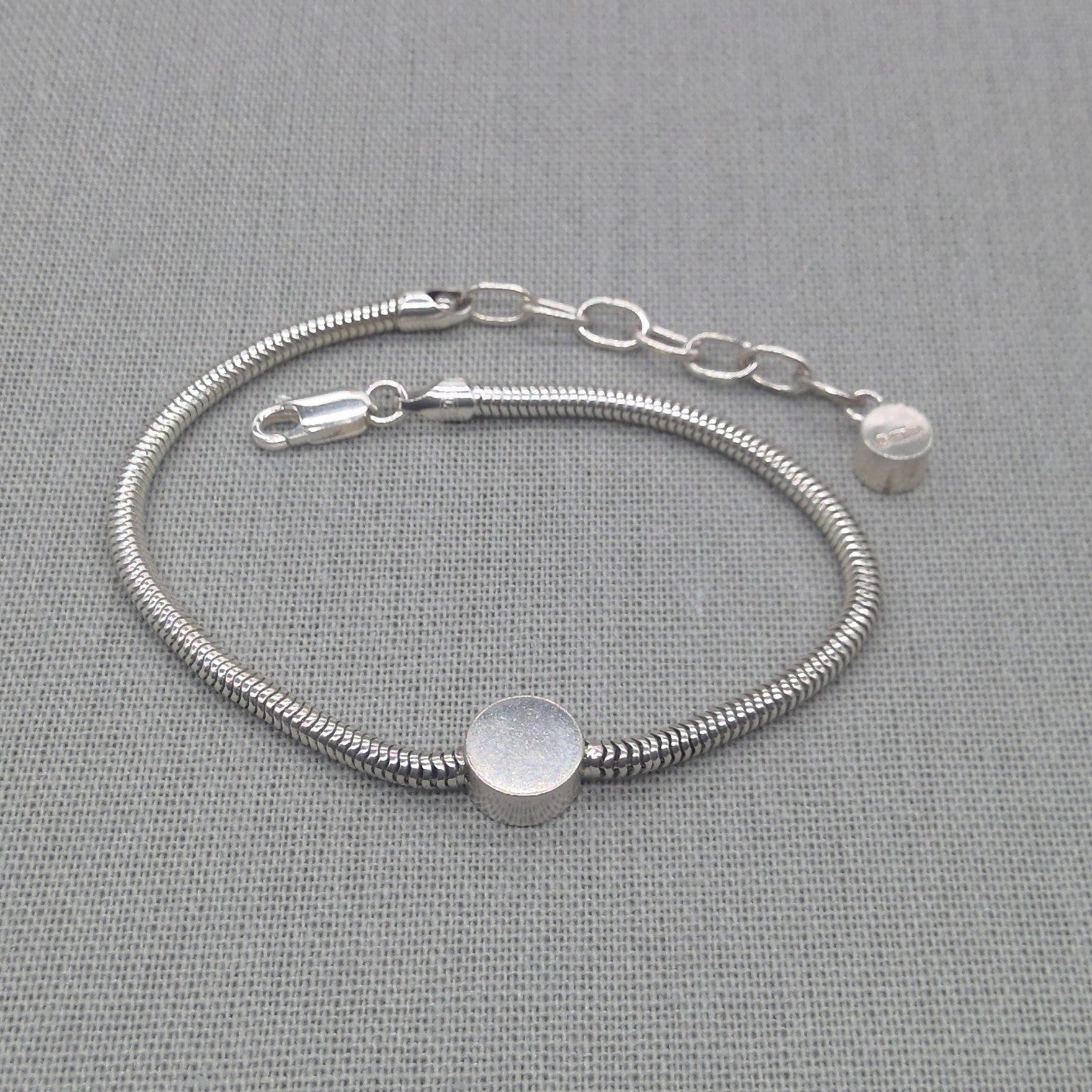 Detail of adjustable clasp on silver snake chain bracelet