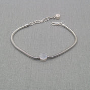 Front view of silver snake chain bracelet showing disc detail