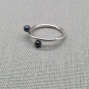 Side view of recycled silver ring with black bead detail