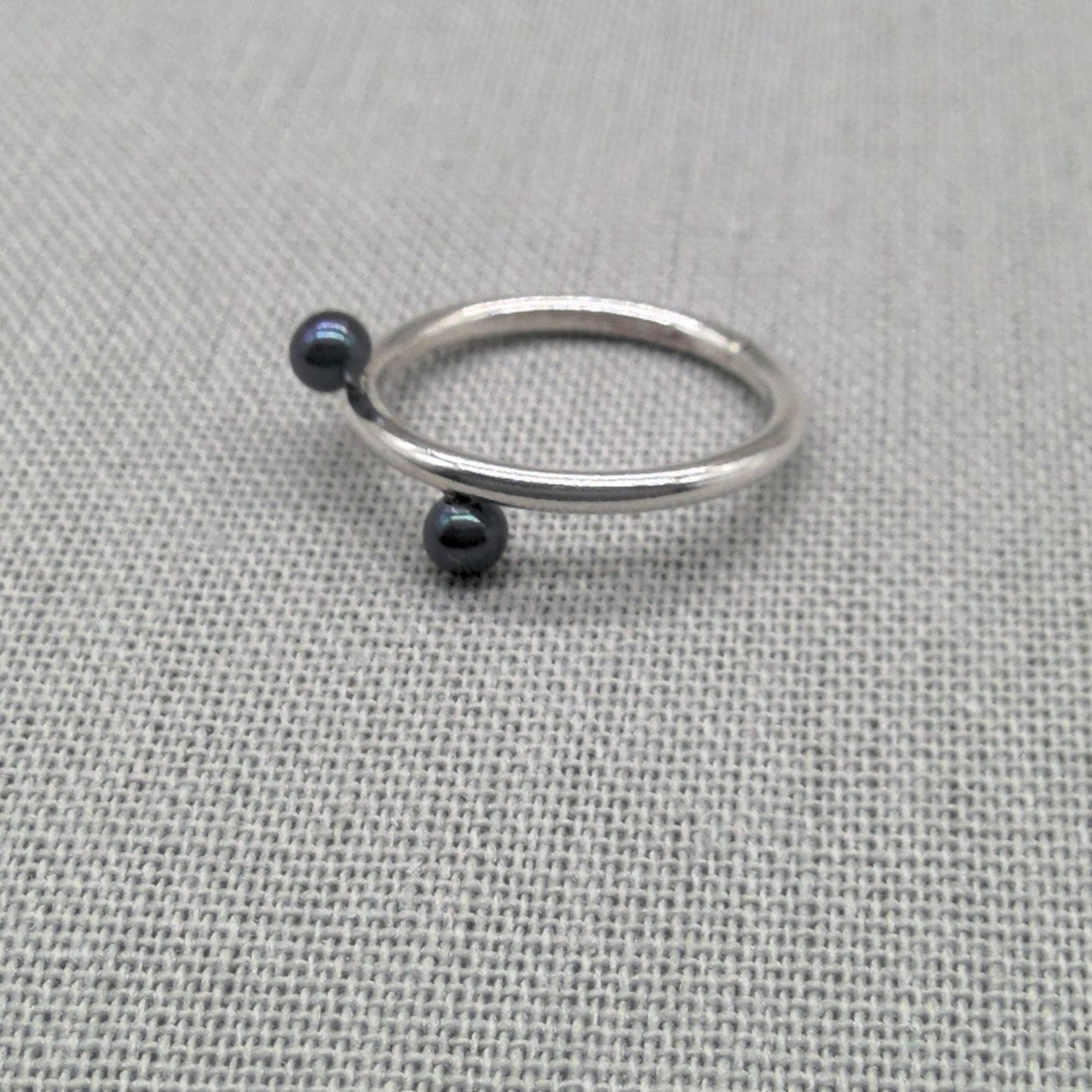 Side view of recycled silver ring with black bead detail