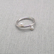 Silver wrap ring featuring two white pearl ends
