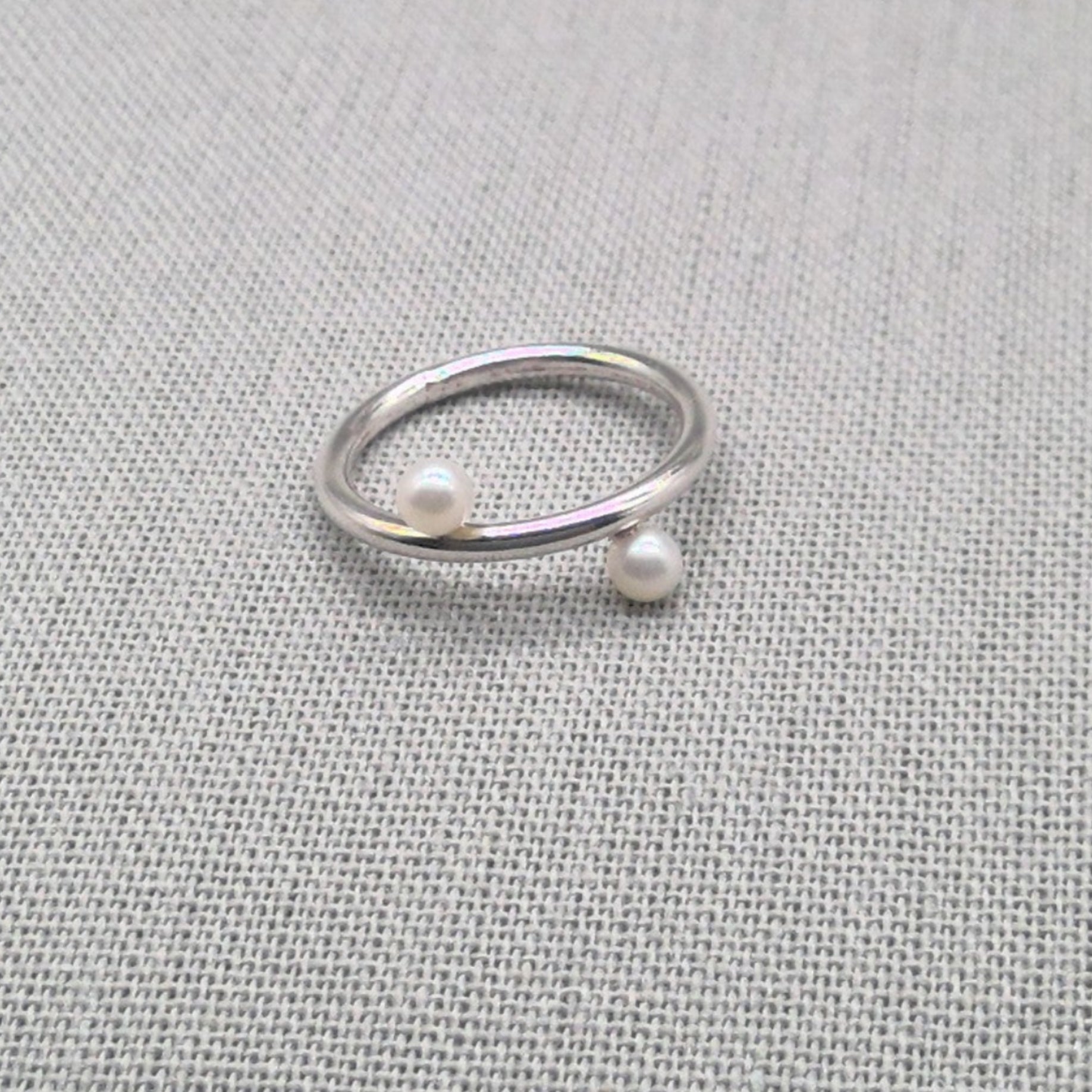 Silver wrap ring featuring two white pearl ends