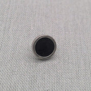 Close-up of black resin recycled silver stud earring