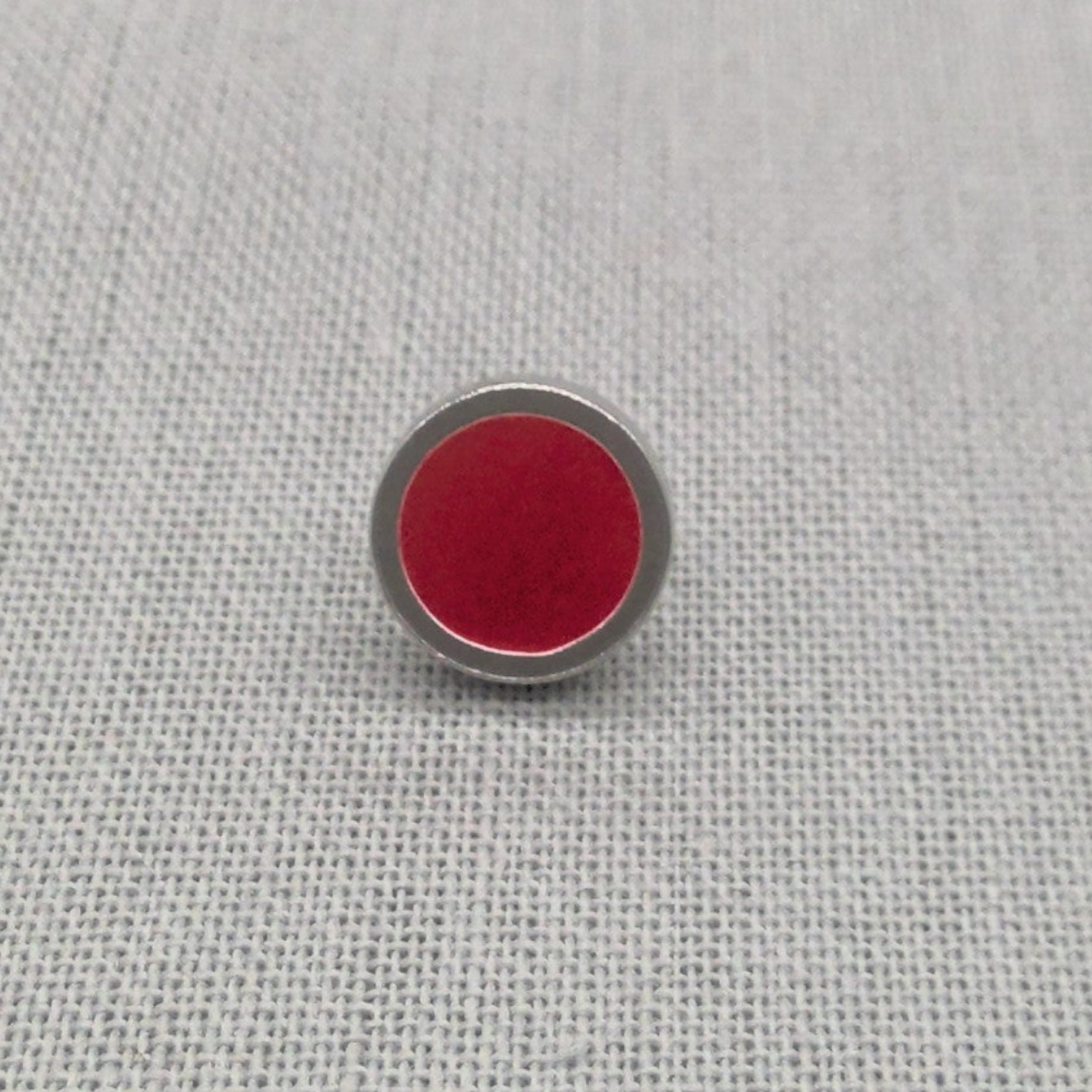 Close-up of red resin recycled silver stud earring