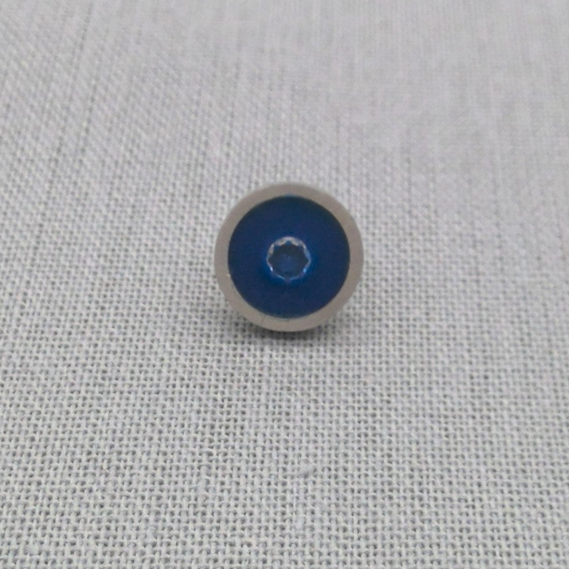 Close-up of blue resin and zircon recycled silver stud earring