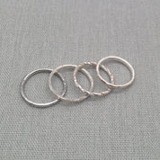 Flat lay of textured recycled silver stacking ring set