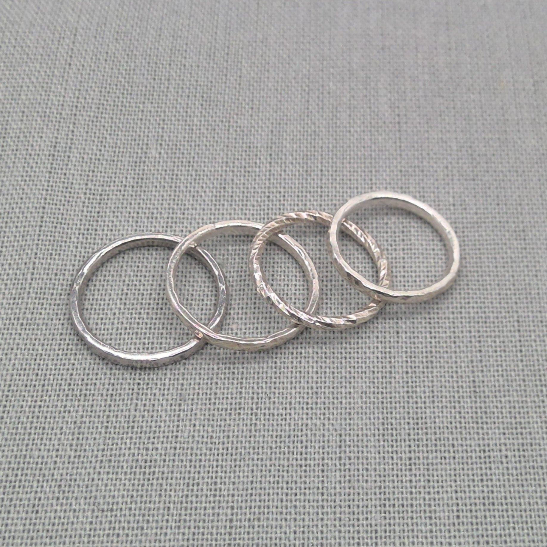 Flat lay of textured recycled silver stacking ring set