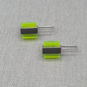 Angled view of two-tone neon Perspex silver stud earrings